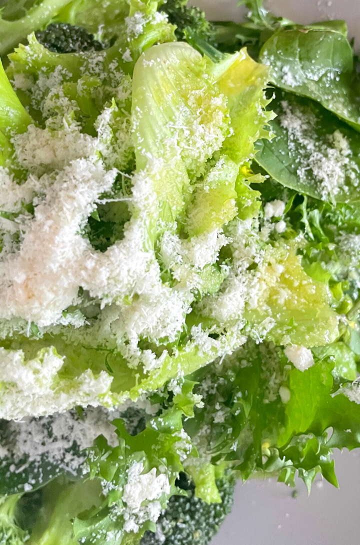 green salad bowl with shredded cheese